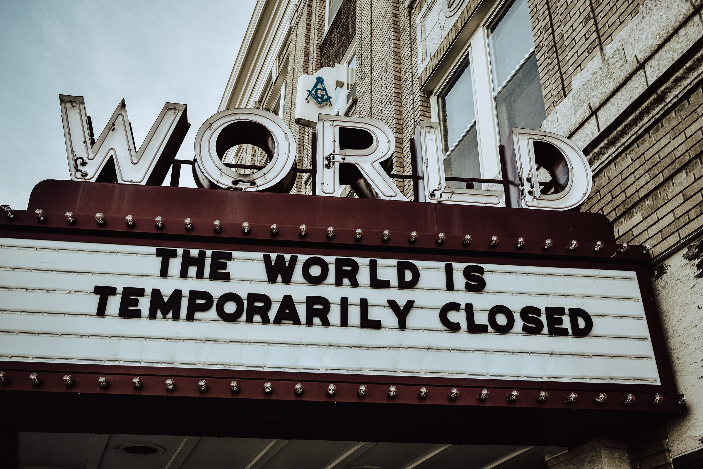 World Theater with text the World is Temporarily Closed on its marquee