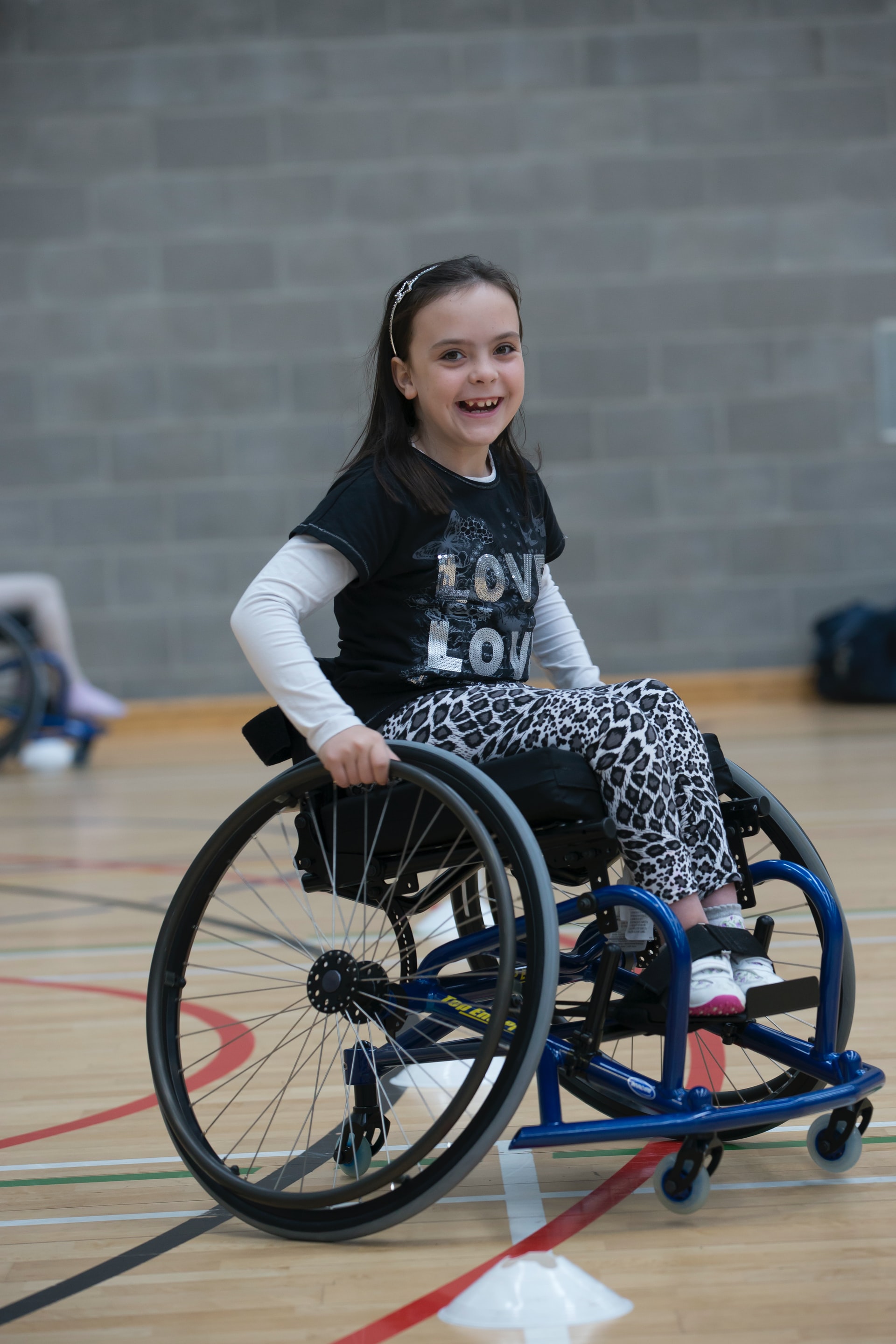 girl playing basketball in wheelchair