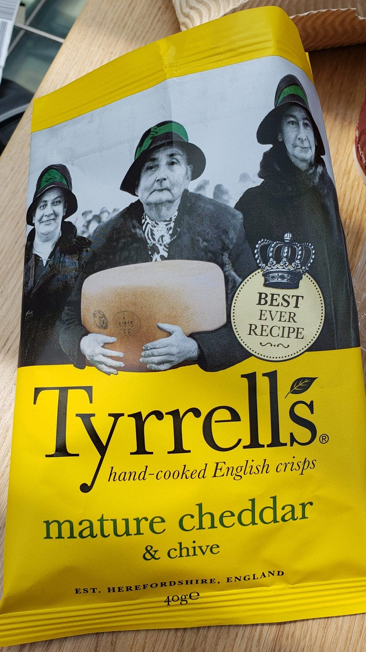 Potato chip bag highlighting a black and white photo of moderately grumpy old women holding a wheel of cheese