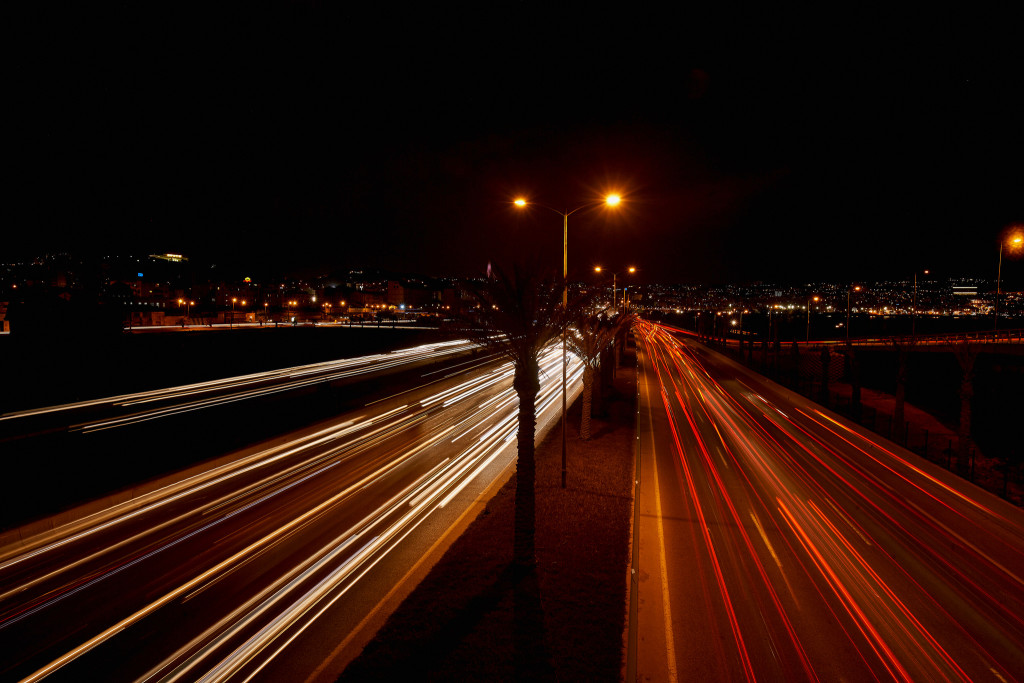 Photo at night of highway and city lights