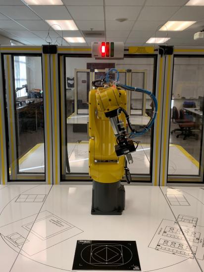 robot cell centered with red light indicating active