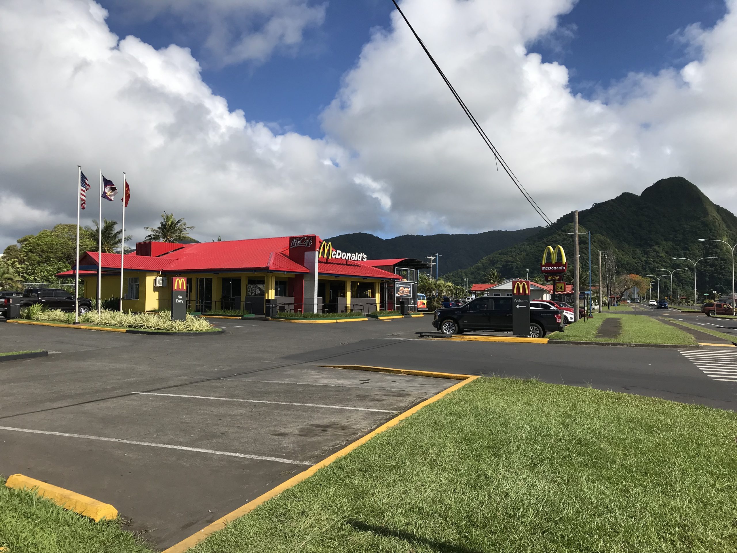 a McDonald's restaurant with parking lot in the foreground