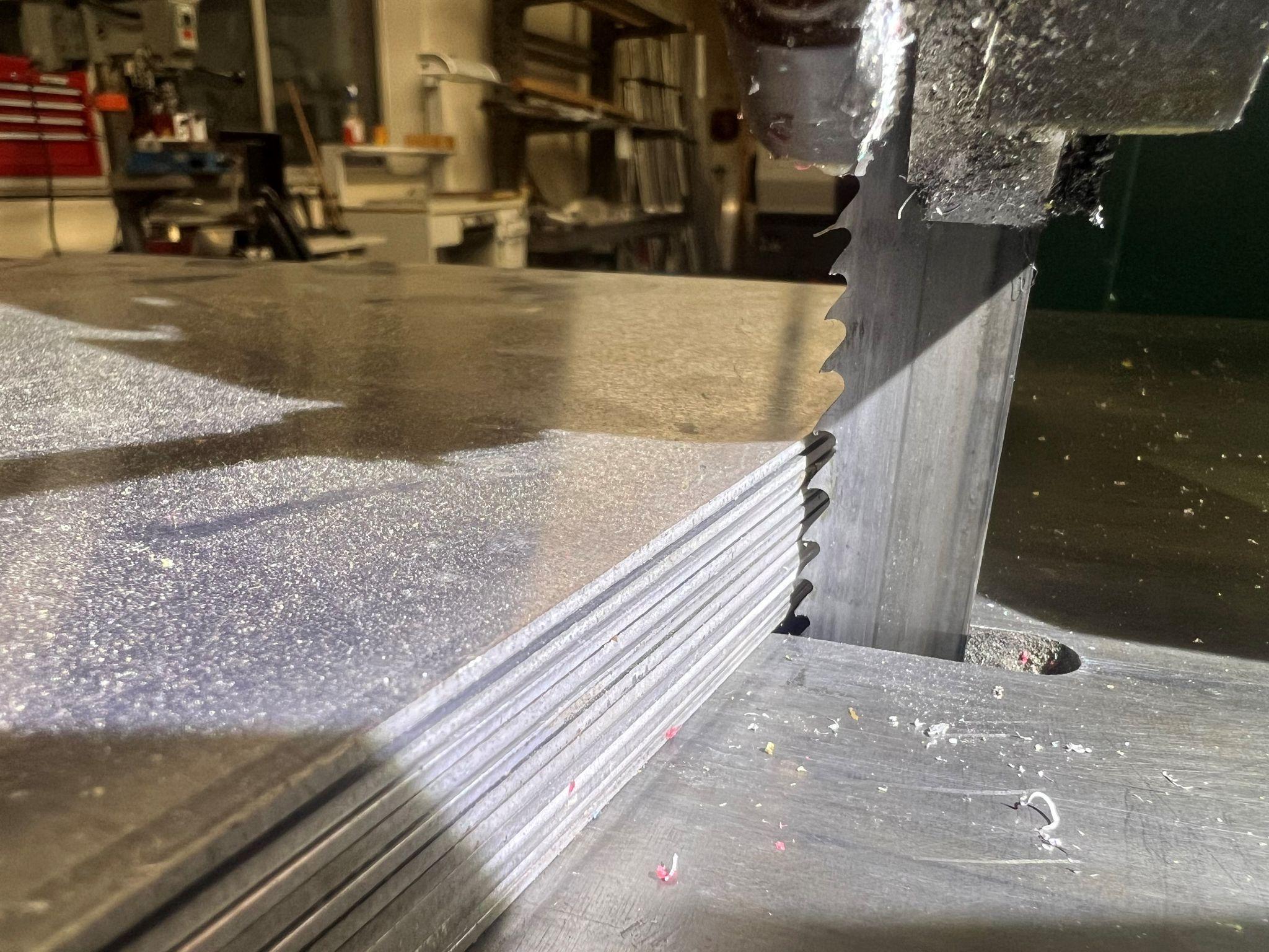 A stack of thin parts being cut.
