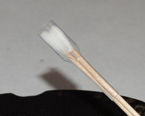 Cotton swabs pulled back so covered by applicator shield
