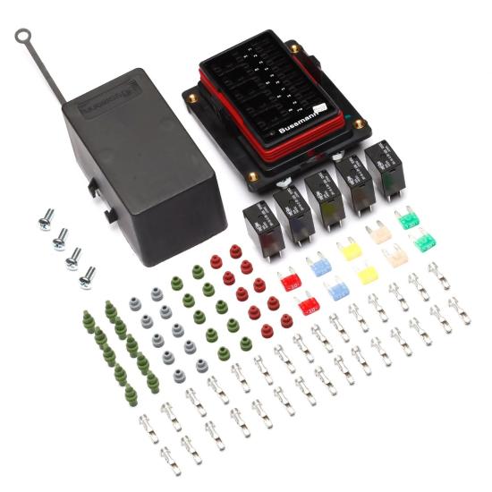 A collection of electronic components, including a black box, connectors, screws, and various colored terminals arranged neatly.