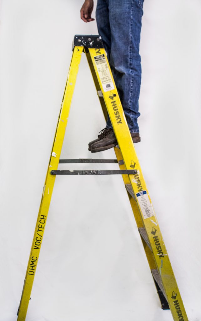 Lower half of a man, just legs, on a Ladder Safe Step
