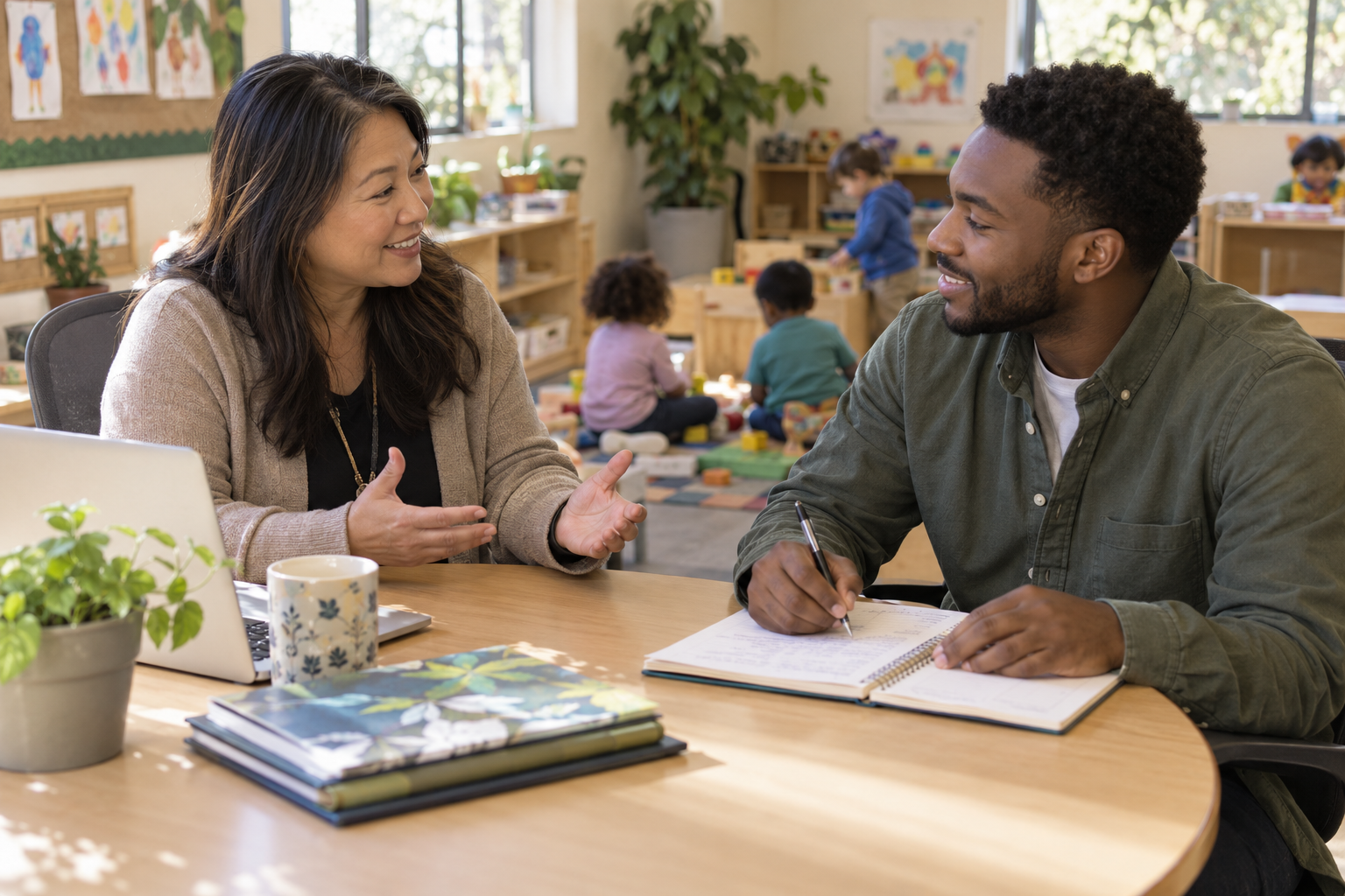 An administrator and educator discuss professional goals while the educator takes notes.