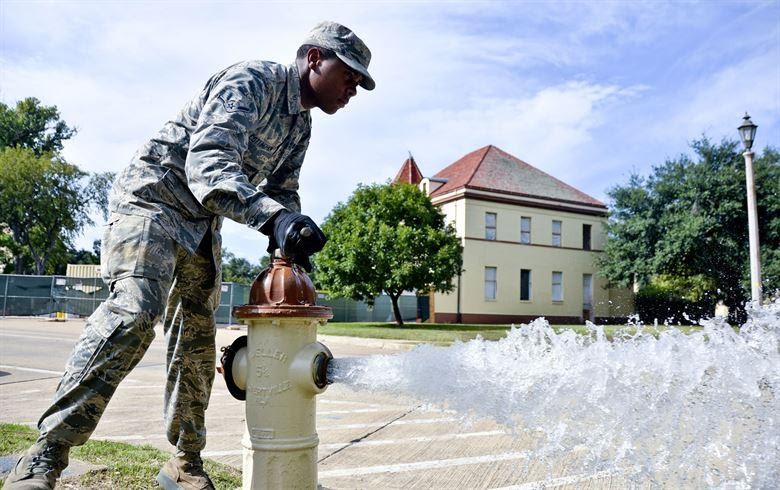 Airman Jeremiah Cottinghan, 2nd Civil Engineer Squadron Water and Fuel Systems Maintenance, flushes a hydrant on Barksdale Air Force Base, La., Sept. 26, 2014. Flushing the system helps prevent corrosion caused by extended exposure to the elements which makes the hydrants ineffective. (U.S. Air Force photo/Airman 1st Class Mozer O. Da Cunha)