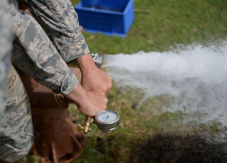Senior Airman Brad Stevens, 36th Civil Engineer Squadron water and fuels systems journeyman, performs a fire hydrant flow test April 30 at Andersen Air Force Base, Guam. Water and fuels systems maintainers also repair, maintain or replace washers, valve seats, leaking faucets and interior, exterior water and sewer lines. (U.S. Air Force photo by Airman 1st Class Joshua Smoot/Released)