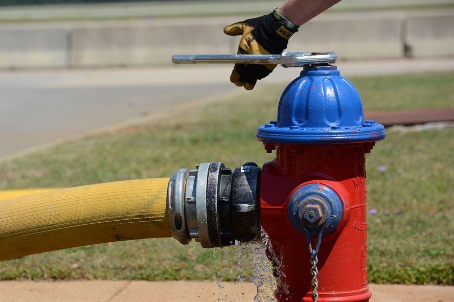 U. S. Air Force Airman 1st Class Zach Fowler, 20th Civil Engineer squadron fire department firefighter, releases water from a fire hydrant into a hose at Shaw Air Force Base, S.C., May 16, 2013.  The firefighters train weekly on structural firefighting, aircraft firefighting, hazardous materials, rescue operations including confined space and also vehicle extrication. (U.S. Air Force photo by Airman 1st Class Nicole Sikorski/Released).