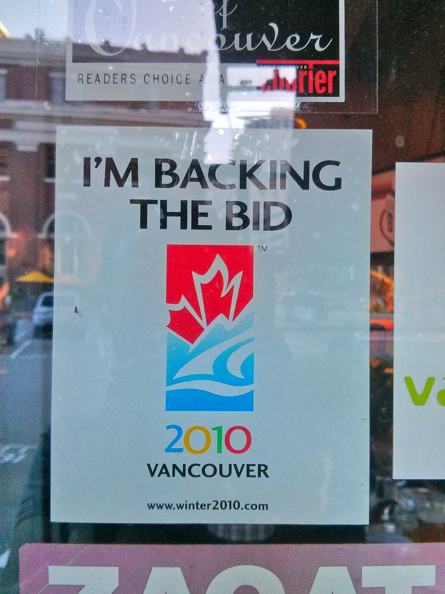 A sign posted on a window reads, "I'm backing the bid. 2010 Vancouver."